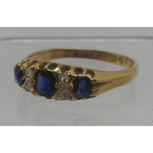 297 - Sapphire and diamond ring set in 18ct gold.  The three sapphires separated by rose cut diamonds.  Ri... 