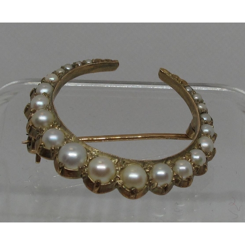 302 - Pearl set crescent brooch of twenty one graduated pearls set in 9ct gold.  Diameter approx 30mm. App... 