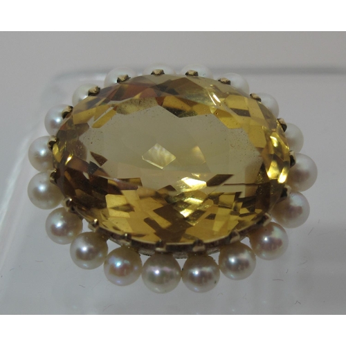 303 - Citrine and pearl brooch.  The large oval citrine approx 23x18mm surrounded by nineteen cultured pea... 