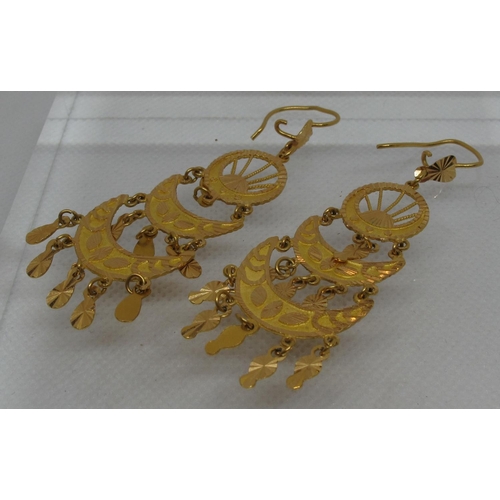 307 - A pair of Indian pendant earrings.  Yellow metal tests as 18ct gold.  Approx weight 13.4 grams.
(B.P... 