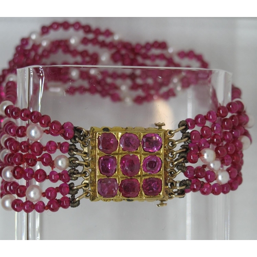 317 - A ruby and cultured pearl bracelet the synthetic ruby beads and cultured pearls having a yellow meta... 