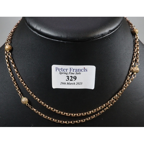 329 - A long Victorian chain with engraved gold beads.  Length 33 inches (34cm).  Approx weight 14.7 grams... 