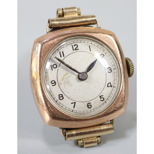 340 - 9ct gold ladies cushion shaped watch with circular face, having Arabic numerals on a gold plated bra... 