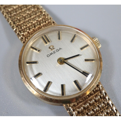 354 - Omega 9ct gold ladies bracelet wristwatch, having satin face with baton numerals and a 9ct gold mesh... 