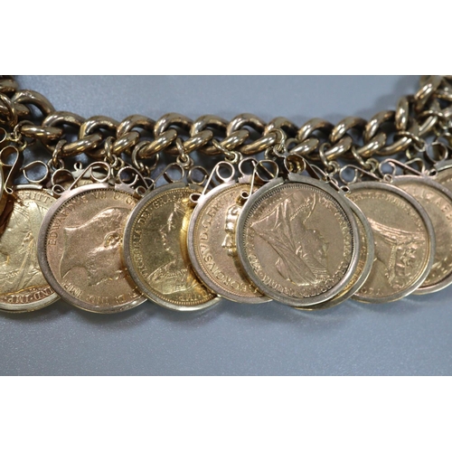 395 - 9ct gold curb link bracelet with heart padlock, set with 20 gold full sovereigns ,in pendant mounts ... 