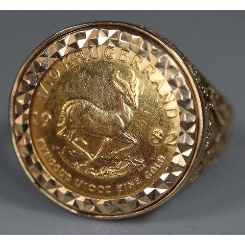 410 - 1/10 Krugerrand gold coin dated 1982 in a 9ct gold foliate and pierced ring mount. 6.1g approx. 
(B.... 