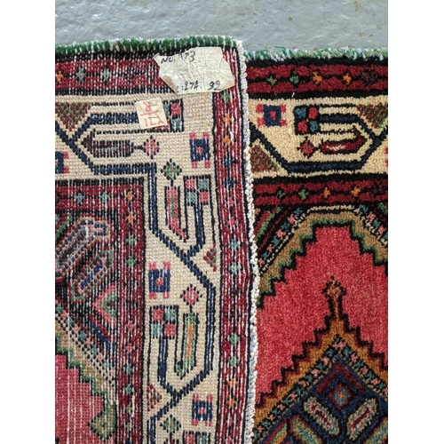 426 - Washed red ground Persian Meshkin runner with diamond medallion geometric design.  274x92cm approx. ... 