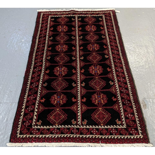 427 - Full pile deep ground red Persian Beluch tribal rug with diamond and geometric medallions.  206x125c... 