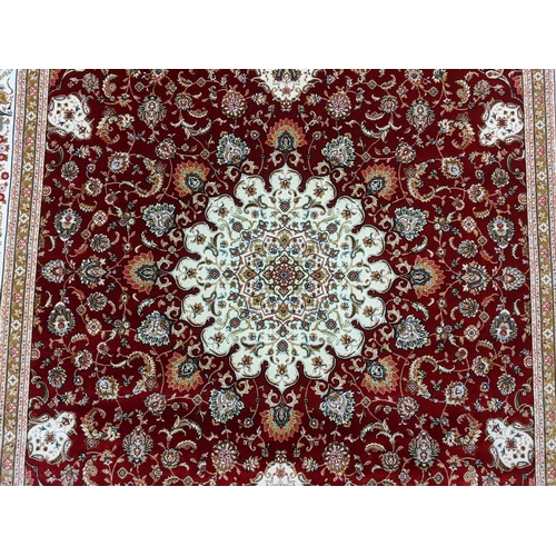 428 - Fine woven bamboo silk red ground rug with central foliate medallion and animal motifs including sty... 