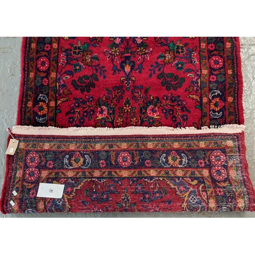 429 - Large thick pile Persian runner on a red ground with floral and foliate design.  330x106cm approx.  ... 