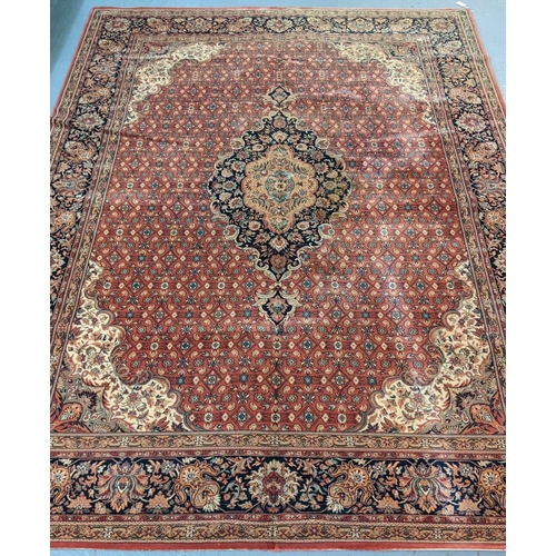 431 - Terracotta ground full wool pile Persian carpet with central medallion floral and foliate designs.  ... 