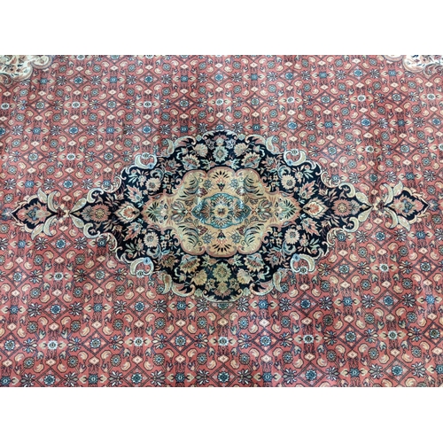 431 - Terracotta ground full wool pile Persian carpet with central medallion floral and foliate designs.  ... 