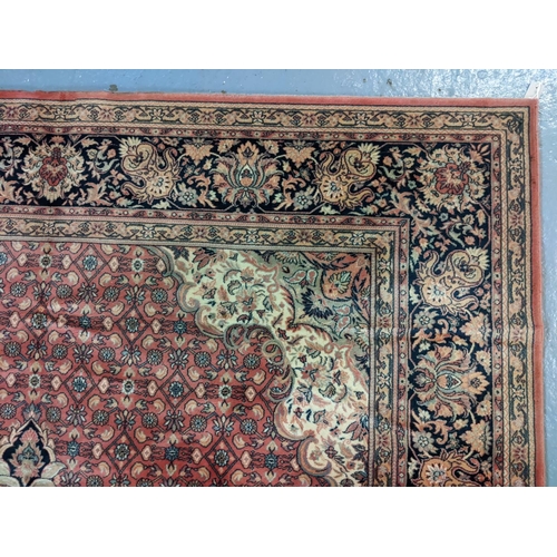 431 - Terracotta ground full wool pile Persian carpet with central medallion floral and foliate designs.  ... 