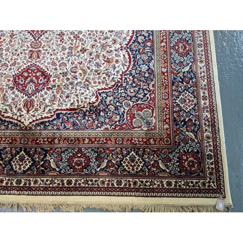 433 - Ivory ground Kashmir full pile carpet with floral medallion and decorated with other flowers, foliag... 