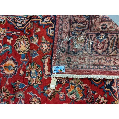 436 - Red ground Persian Mashad carpet having floral medallion to the centre.  300x197cm approx.   (B.P. 2... 