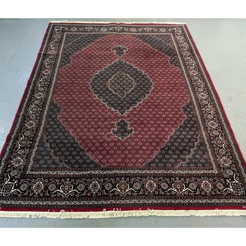 437 - Rich red ground full pile Iranian carpet of Persian Kashan design.   (B.P. 21% + VAT)