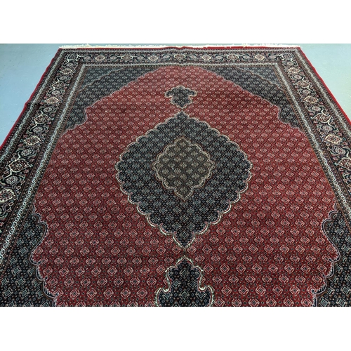 437 - Rich red ground full pile Iranian carpet of Persian Kashan design.   (B.P. 21% + VAT)