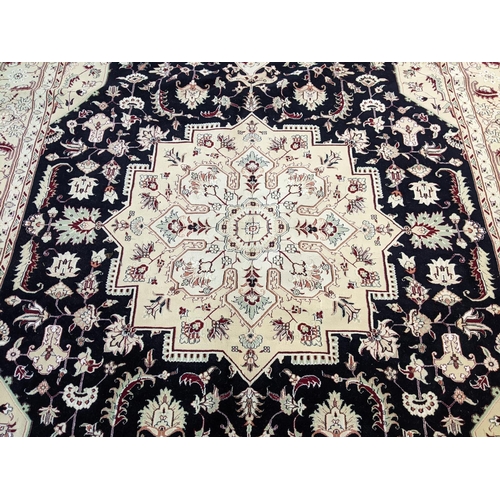 439 - Rich blue and ivory ground Iranian carpet with Heriz design (Northern Iran).  330x246cm approx.   (B... 