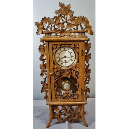 71 - German Black Forest design foliate decorated mantle clock, having white Roman face and exposed pendu... 