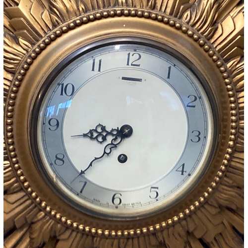 72 - Early 20th century Smiths eight day gilded sunburst clock with Arabic face. With key.  Overall 67cm ... 