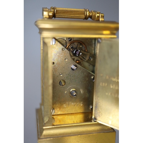 73 - Miniature gilt brass carriage clock with silvered and enamelled face and side panels decorated with ... 