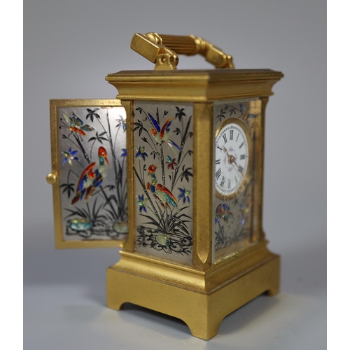 73 - Miniature gilt brass carriage clock with silvered and enamelled face and side panels decorated with ... 