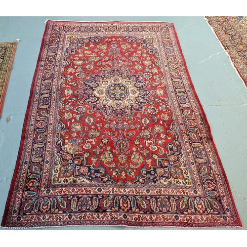 436 - Red ground Persian Mashad carpet having floral medallion to the centre.  300x197cm approx.   (B.P. 2... 