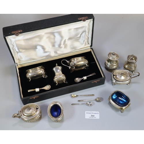 264 - Cased set of silver condiments with blue glass liners, to include: mustard pots, spoons etc, togethe... 