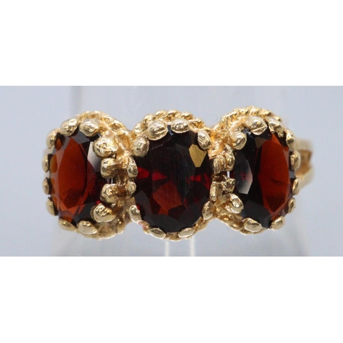 267 - Garnet ring of three oval stones set in 9ct gold.  Ring size Q&1/2.  Approx weight 3.6 grams.
(B.P. ... 