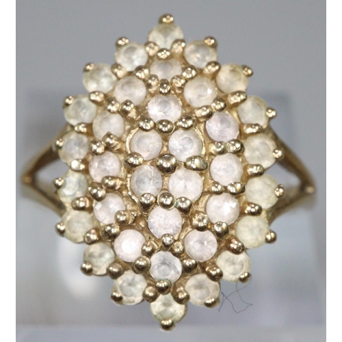 277 - 9ct gold dress ring set with a cluster of white stones.  Ring size R&1/2.  Approx weight 4.6 grams.
... 