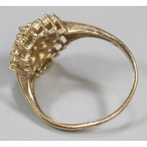 277 - 9ct gold dress ring set with a cluster of white stones.  Ring size R&1/2.  Approx weight 4.6 grams.
... 