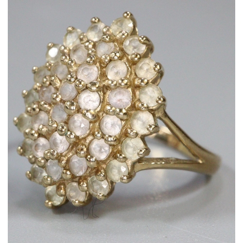 277 - 9ct gold dress ring set with a cluster of white stones.  Ring size R&1/2.  Approx weight 4.6 grams.
... 