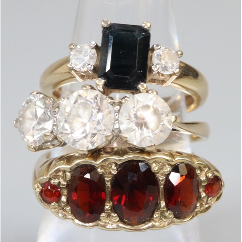 299 - Two 9ct gold stone set dress rings and a yellow metal dress ring.  Ring size O, O and K.  Approx wei... 