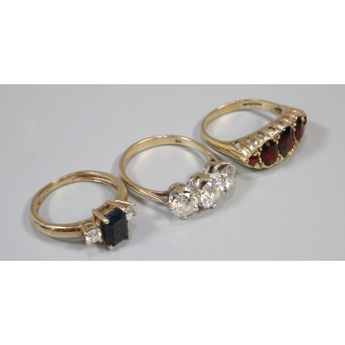 299 - Two 9ct gold stone set dress rings and a yellow metal dress ring.  Ring size O, O and K.  Approx wei... 