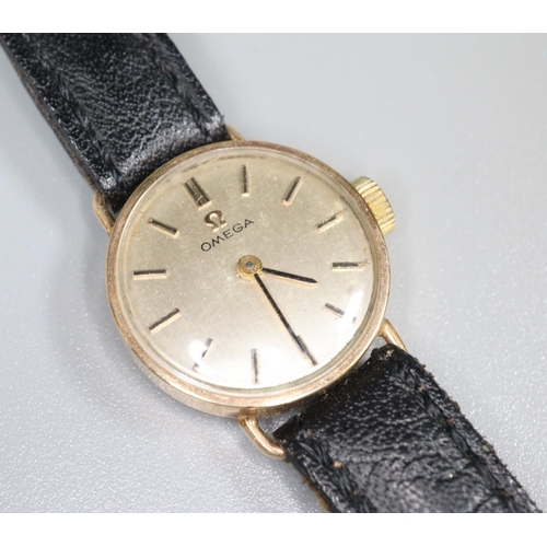 326 - Omega 9ct gold ladies mechanical wristwatch with satin face having baton numerals, on leather strap.... 