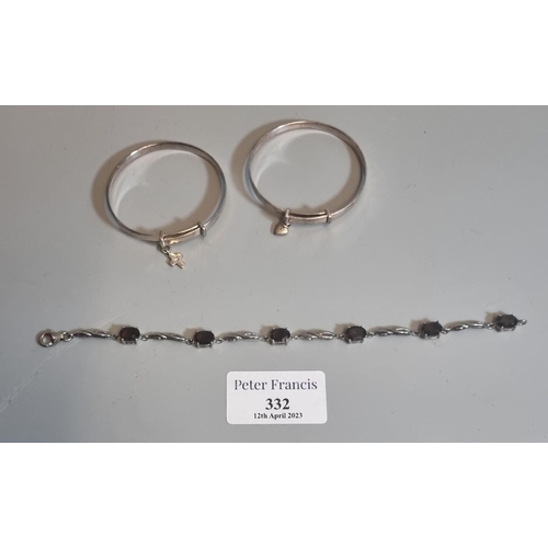 332 - Two silver christening bangles and a silver bracelet set with smokey quartz stones.
(B.P. 21% + VAT)