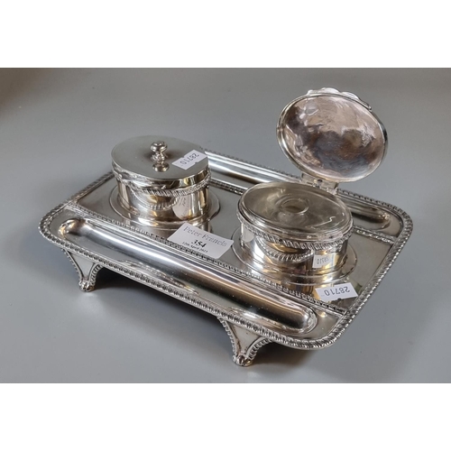 354 - Victorian silver double desk inkwell with two pen trays having gadrooned edges on four scroll and sh... 