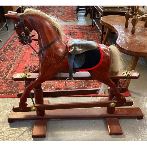 565 - Modern child's rocking horse standing on a stained swing frame. (B.P. 21% + VAT)