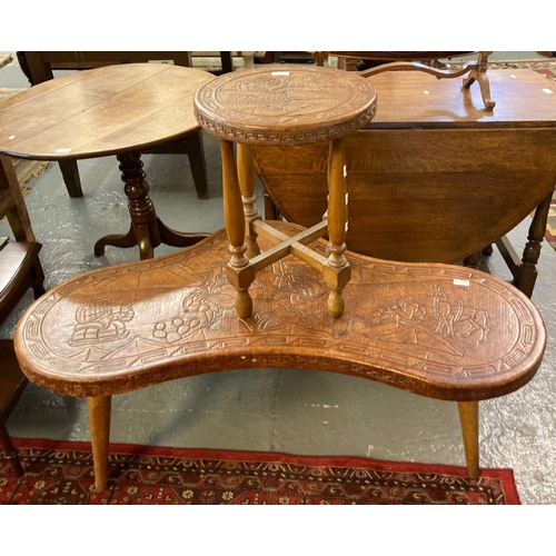 566 - Unusual modern leather top shaped coffee table decorated with European figures and Lama, together wi... 