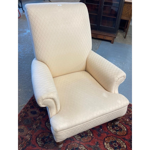 584 - 19th century library arm chair, reupholstered with scrolled arms and back on turned legs with brass ... 