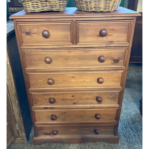 590 - Modern natural pine chest of two short and five long drawers with moulded framing and turned nobs.  ... 