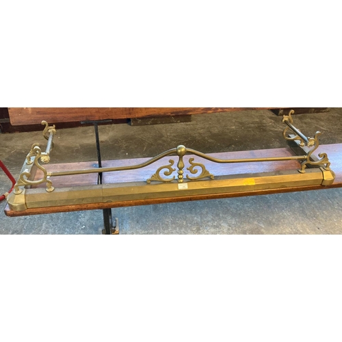 596 - Adjustable brass fender with scrolled bars and andirons.   (B.P. 21% + VAT)