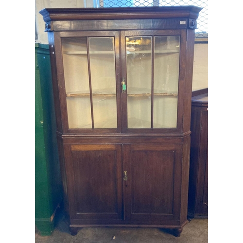 600 - 19th century Welsh oak glazed double corner cupboard with shaped shelves to the interior and two bli... 