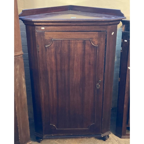 601 - 19th century mahogany blind panelled corner cupboard, now on bun feet with low gallery back, shaped ... 