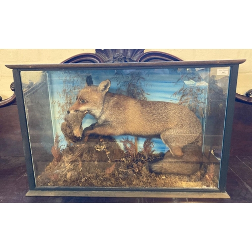 607 - Taxidermy; cased specimen juvenile Fox with English partridge amongst foliage.   (B.P. 21% + VAT)