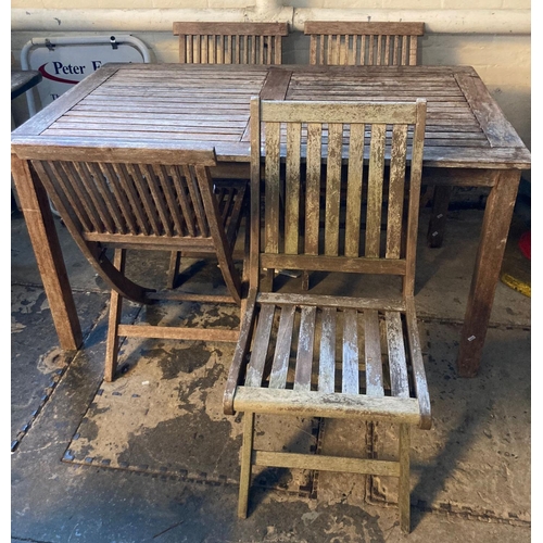 610 - Teak garden table and four matching chairs in weathered condition.  (5)   (B.P. 21% + VAT)