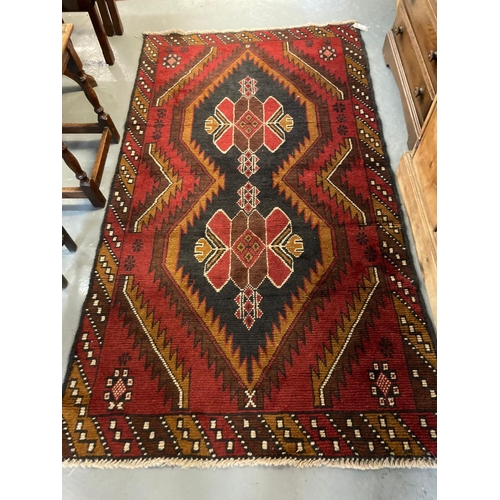 631 - Afghan Belouchi red ground geometric design tribal rug.  190x107cm approx.   (B.P. 21% + VAT)