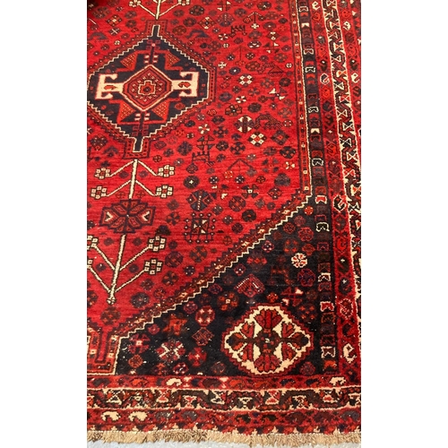 635 - Middle Eastern red ground foliate design rug with banded border.  245x177cm approx.   (B.P. 21% + VA... 