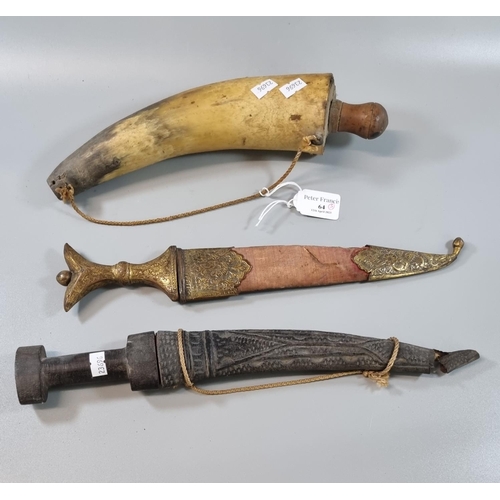 64 - Horn powder flask with turned wooded handle together with two Middle Eastern daggers, one with yello... 