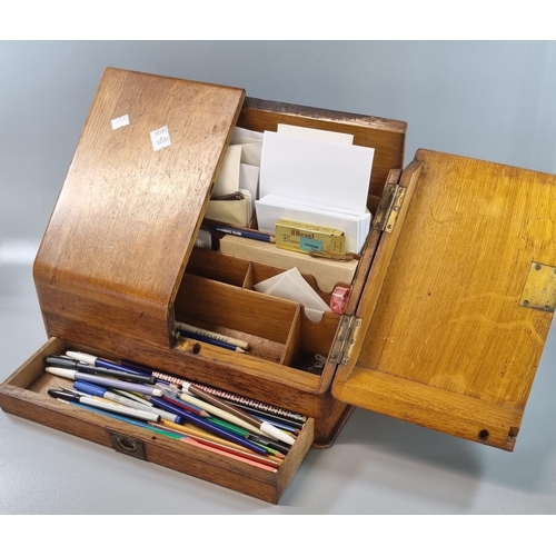 95 - Early 20th century pale oak slope front stationary box with pullout drawer, the interior revealing a... 